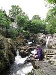 SX23134 Jenni on rocks by Afon Conwy at Betws-Y-Coed.jpg